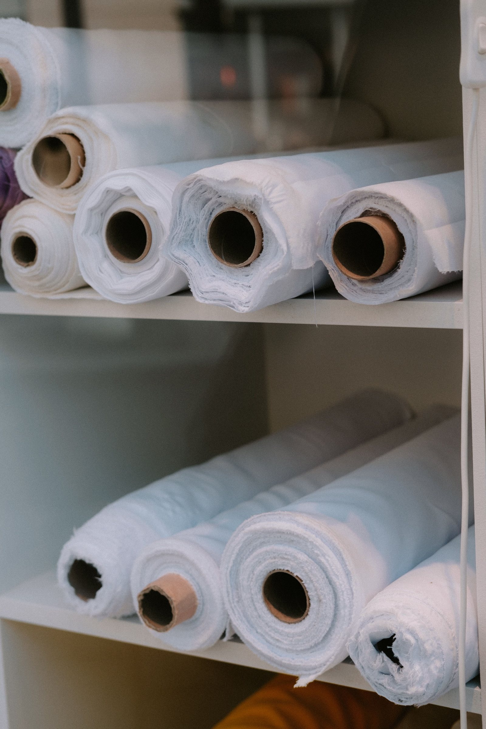 Curtain fabric rolls in a workroom setting